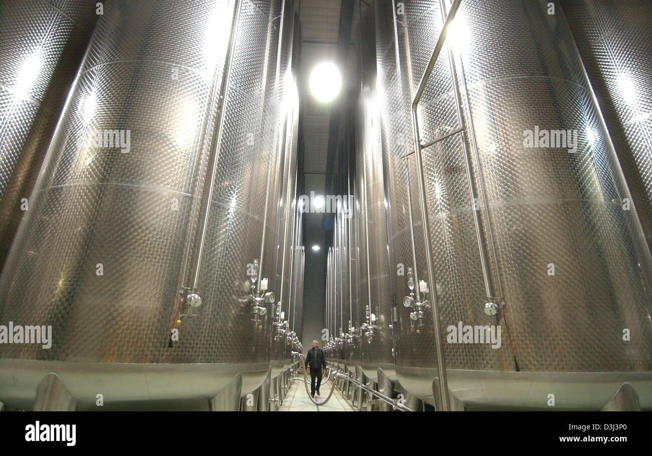 (dpa) An employee walks past 50,000 litre tanks in which fruit juices