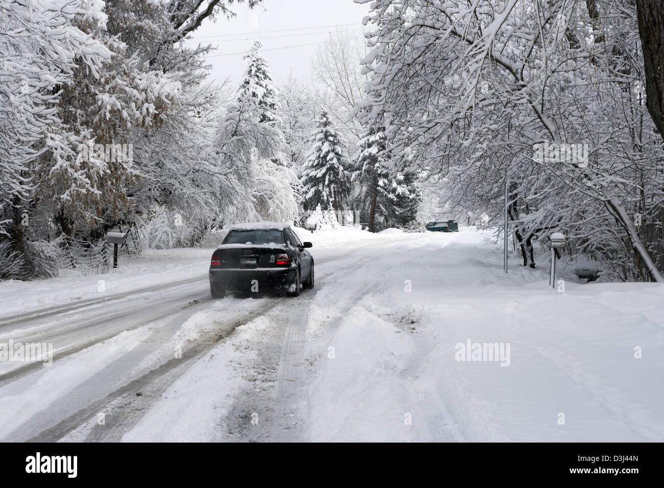 Car driving through fresh snow in a side street in Salt Lake City, Utah ...