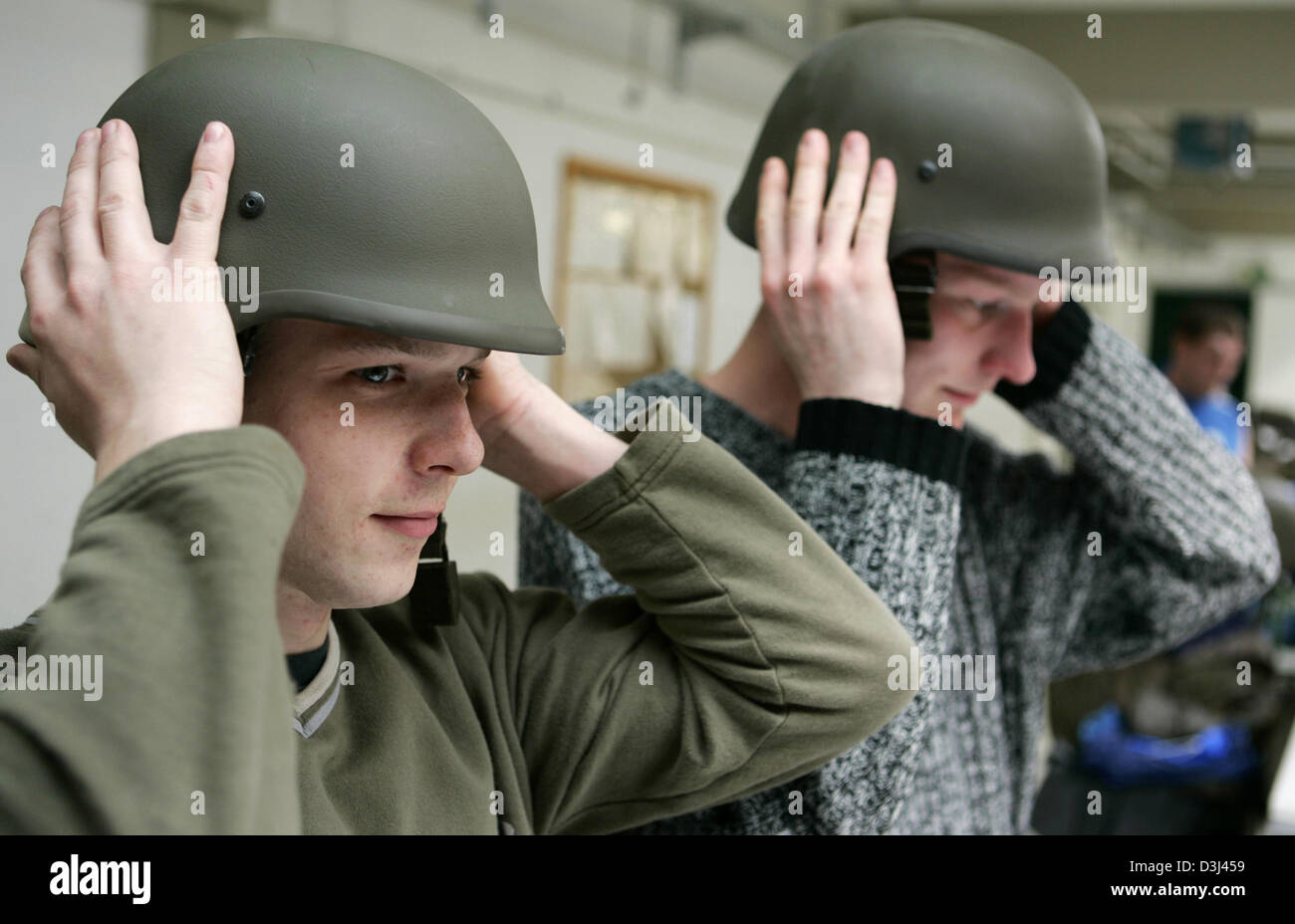 (dpa) - Two conscripts check the fit of their helmets: Dressing of conscripts at the Knuell barracks in Schwarzenborn, Germany, 4 April 2005. Stock Photo