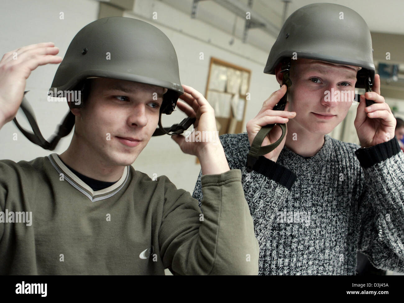 (dpa) - Two conscripts check the fit of their helmets: Dressing of conscripts at the Knuell barracks in Schwarzenborn, Germany, 4 April 2005. Stock Photo