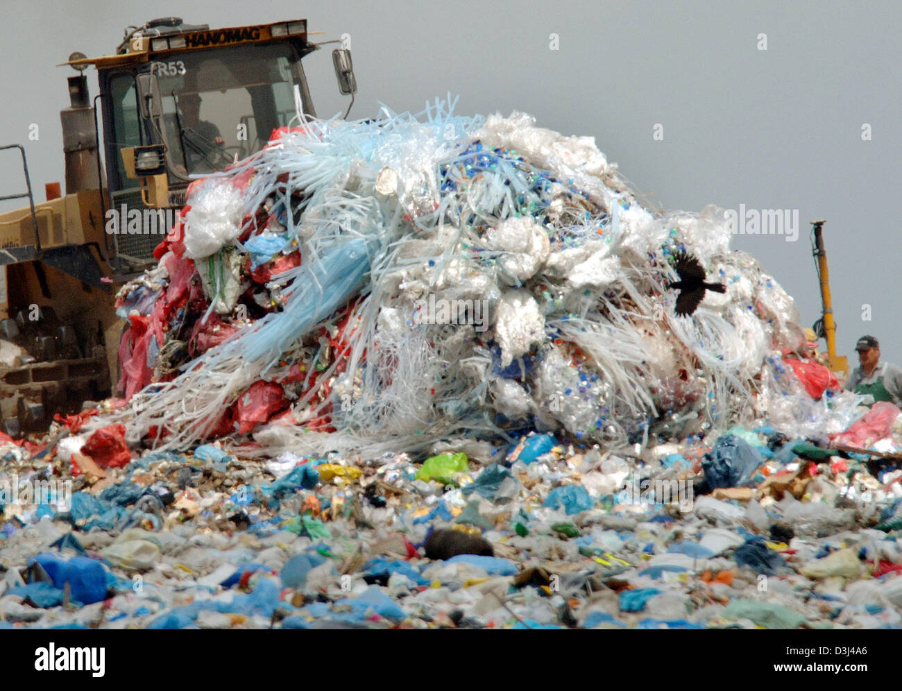 (dpa) - A crawler flatens domestic and industrial waste at the waste deposit of Floersheim-Wicker near Frankfurt, Germany, 31 May 2005. Stock Photo