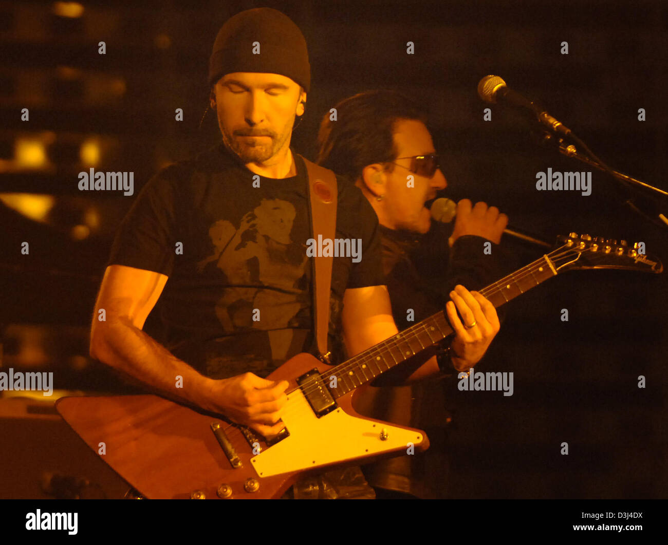 (dpa) - Bono, front-man of the British rock band 'U2' and U2's guitarist The Edge (L) perform during a concert of the band in Gelsenkirchen, Germany, Sunday, 12 June 2005. The band is currently on world tour to promote their album Vertigo. Stock Photo
