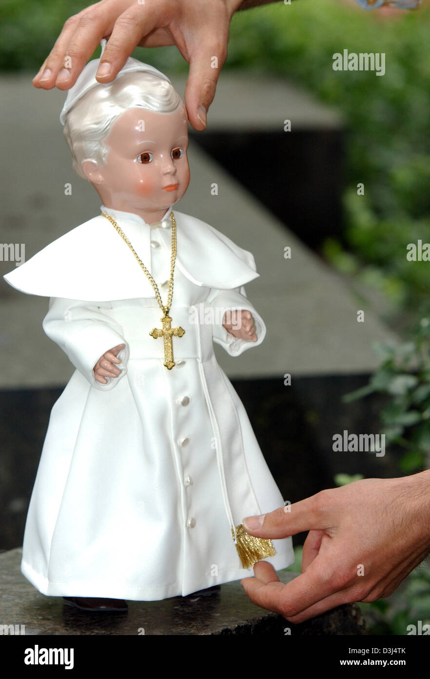 (dpa) - The picture shows the hands of Marcel Offermann, owner of the puppet hospital Neuss, holding a 41 centimetre tall design model of the Pope in Neuss, Germany, Monday 06 June 2005. Together with puppet producer Schildkroet Offermann was responsible for the puppet's design. Arms and legs of the puppet are flexible. The clothes were made according to the real Pope's official cl Stock Photo
