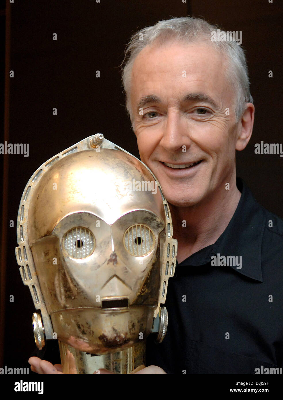 (dpa files) - British actor Anthony Daniels presents the mask of the robot C3PO which he plays in the 'Star Wars' - films since 1977 during a dpa-interview in Stuttgart, Germany. Although his face disappears behind the mask, the actor consideres the part as an artistic challenge, for the awkward air of the robot with its philosophic side notes has profound human lineaments. Stock Photo