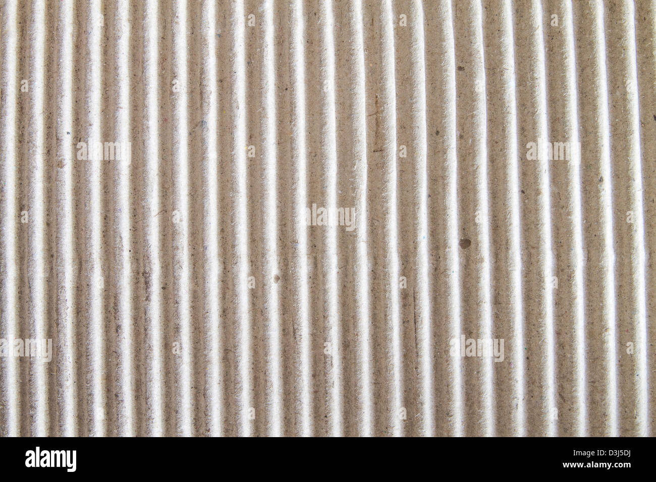 Textured corrugated striped cardboard with natural fiber parts Stock Photo