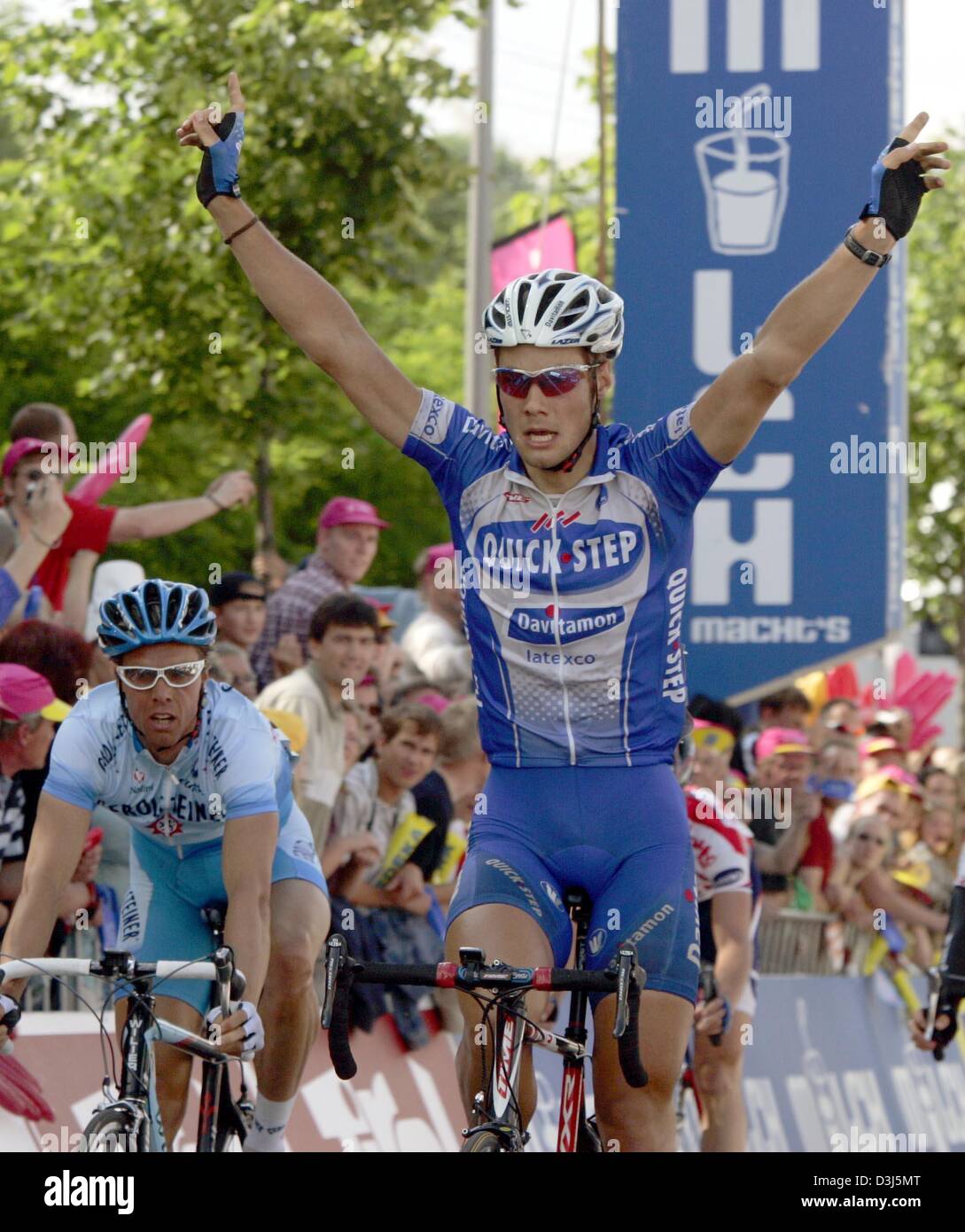 (dpa) - Belgian cycling pro Tom Boonen (R) of Team Quick-Step Davitamon raises his arms and cheers after winning the seventh and final leg of the Tour of Germany cycling race in Leipzig, Germany, 6 June 2004. Boonen won ahead of Danilo Hondo (L) of Team Gerolsteiner. Stock Photo