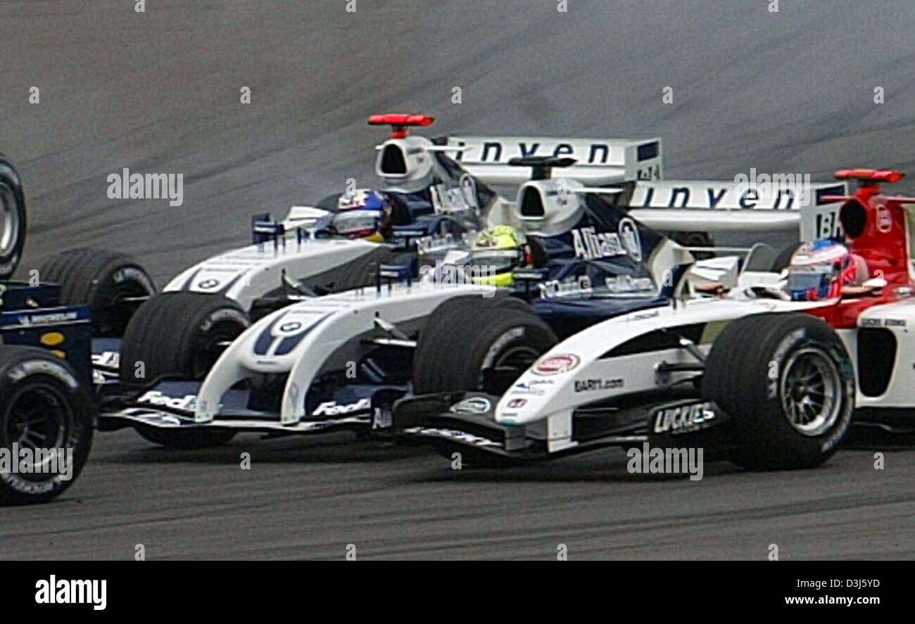 (dpa) - German formula one pilot Ralf Schumacher of BMW-Williams (C)  collides with his Colombian teammate Juan Pablo Montoya (back) in the first bend during the European Grand Prix at the Nuerburgring race track in Germany, 30 May 2004. The crash also involves Brazil's Christiano da Matta (covered) of Toyota. (ITALY OUT) Stock Photo