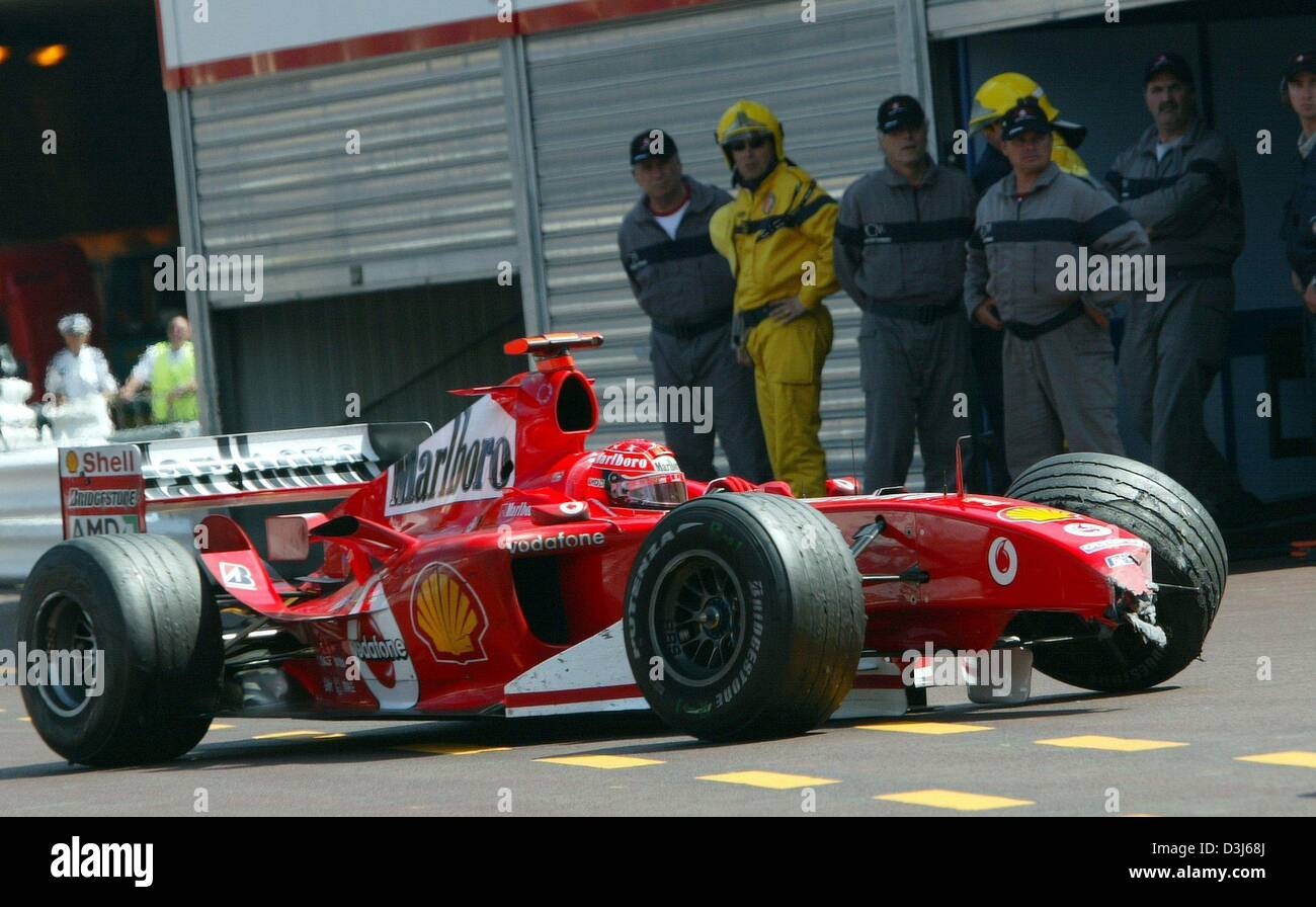 (dpa) - German formula one pilot Michael Schumacher of Ferrari returns with his damaged car to the Ferrari pit after crashing with Colombian formula one pilot  Juan Pablo Montoya during the Formula 1 Grand Prix of Monaco, 23 May 2004. Stock Photo