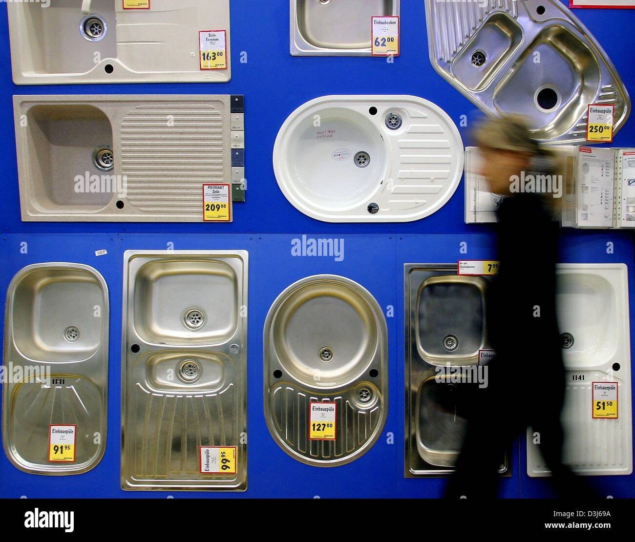 (dpa) A customer in a DIY (Do it Yourself) store walks past a wall