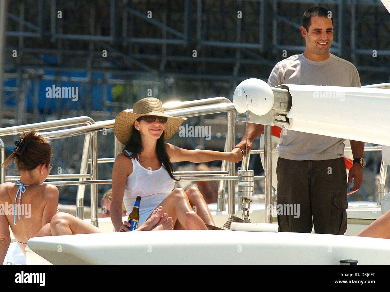 (dpa) - Colombian formula one pilot Juan Pablo Montoya (R) of BMW smiles as he holds hands with his wife Connie on a yacht while enjoying a day off in the harbour of Monaco, 21 May 2004. The Formula 1 Grand Prix of Monaco will be held on Sunday, 23 May 2004. Stock Photo