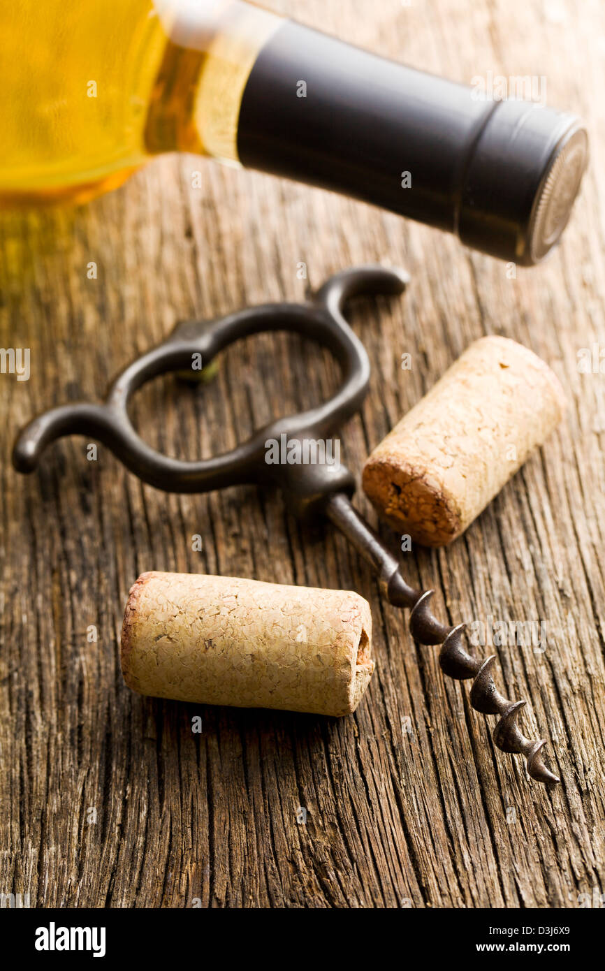 wine cork and corkscrew on wooden table Stock Photo