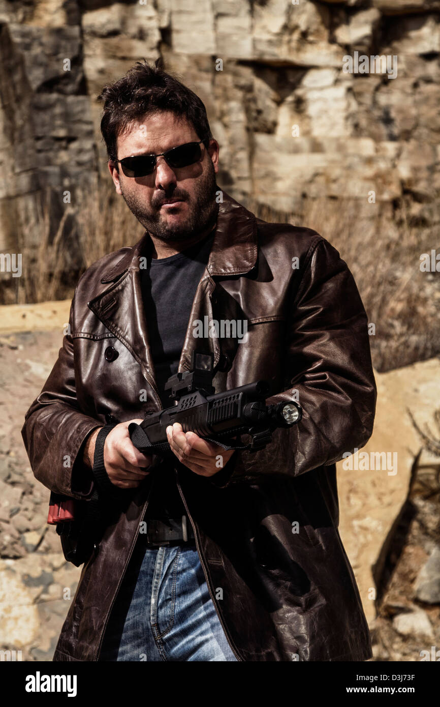 Man in jacket pointing gun hi-res stock photography and images - Alamy