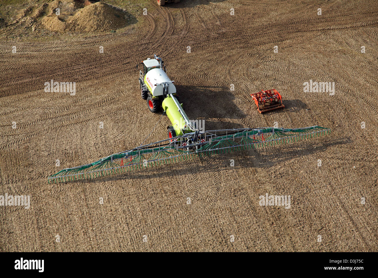 aerial view of an agricultural crop spaying boom being towed by a tractor Stock Photo