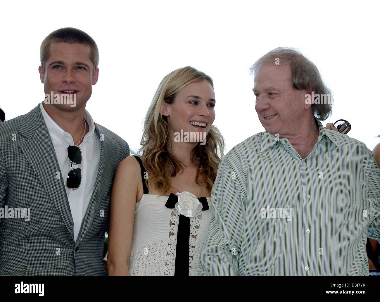 (dpa) - Hollywood star Brad Pitt, German actress Diane Kruger and the German director Wolfgang Petersen (from L to R) present their new movie 'Troy' at the 57th Film Festival in Cannes, France, 13 May 2004. In the movie Pitt stars as Greek hero Achilles and Kruger plays the beautiful Helena. Stock Photo
