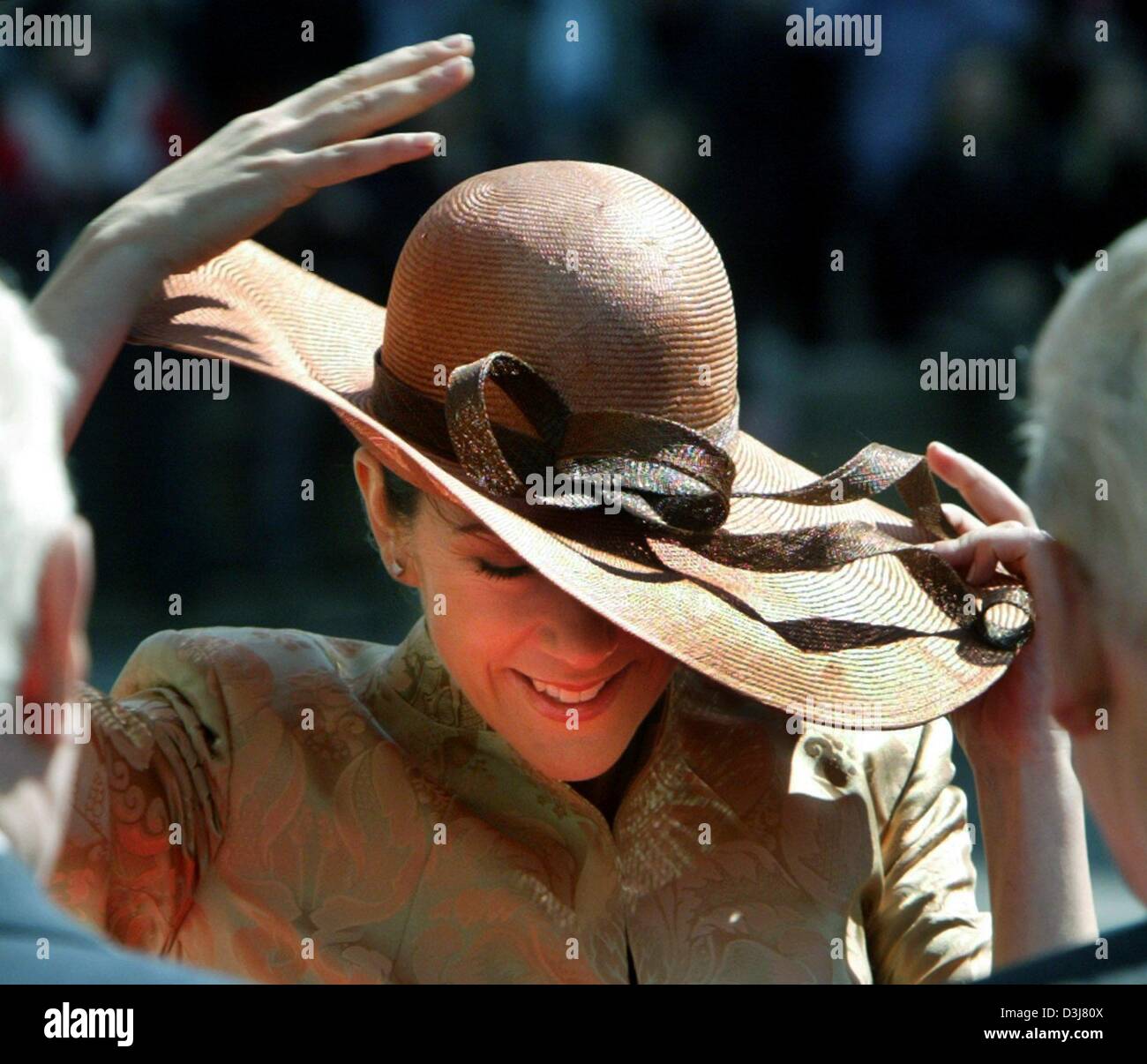(dpa) - Mary Donaldson, the Australian fiancee of Crown Prince Frederik of Denmark, holds on to her hat which had been blown off her head during a visit of the Parliament in Copenhagen, Denmark, 13 May 2004. Donaldson will wed Crown Prince Frederik at the Cathedral in Copenhagen on Friday 14 May 2004. Stock Photo