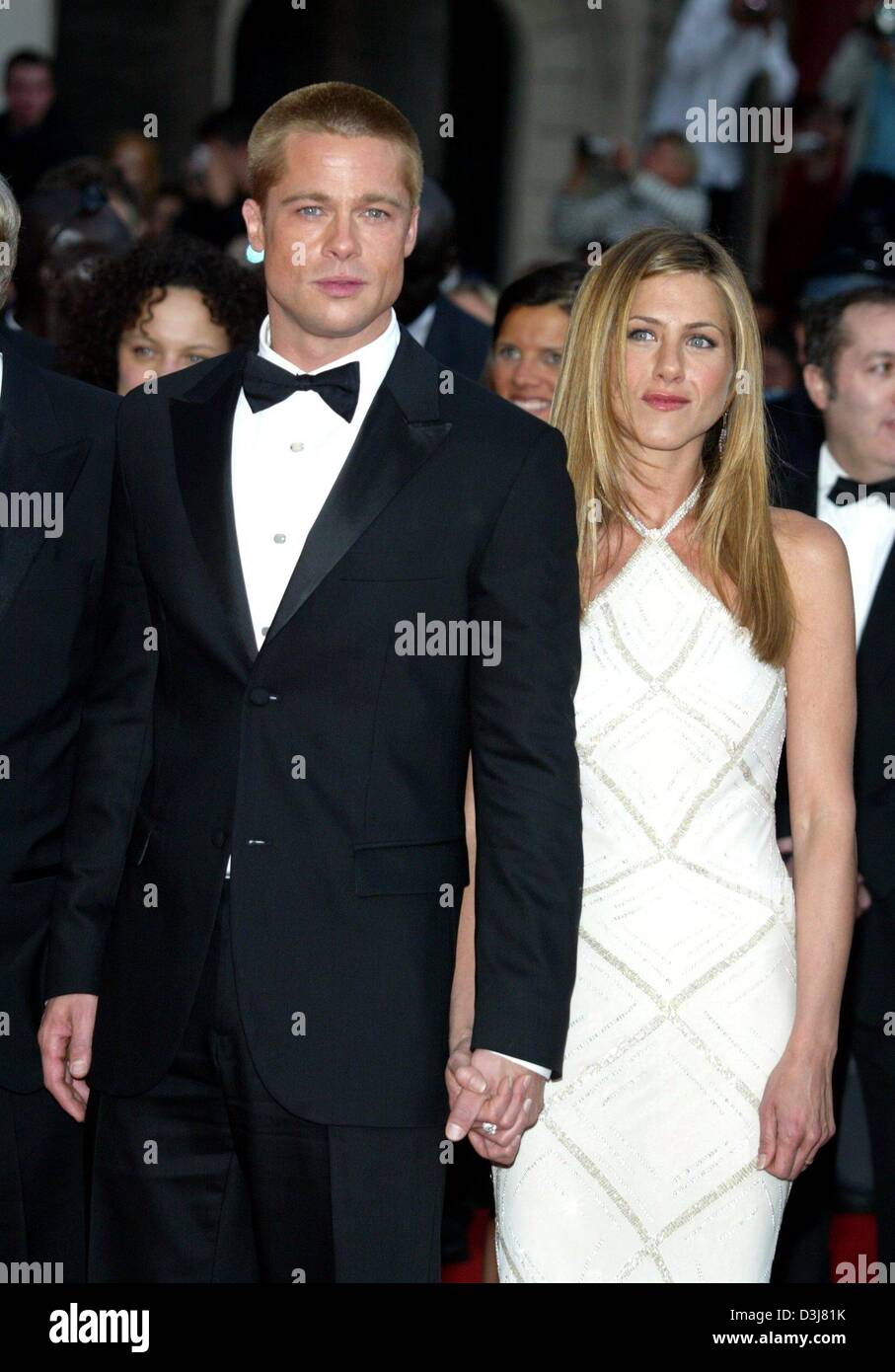 (dpa) - Hollywood star Brad Pitt and his wife Jennifer Aniston pose and hold hands upon their arrival at the presentation of Pitt's new movie 'Troy' at the 57th Film Festival in Cannes, France, 13 May 2004. In the movie Pitt stars as Greek hero Achilles. Stock Photo