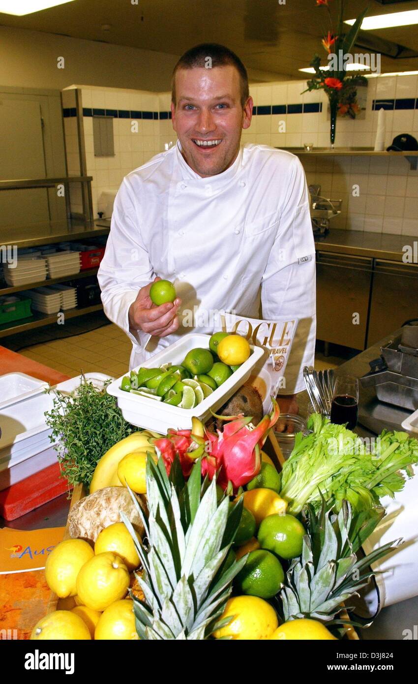 (dpa) - Australian star chef Ben O'Donoghue smiles as poses in front of baskets filled with fresh fruits in the kitchen of the InterContinental hotel in Berlin, 12 May 2004. O'Donoghue presented new culinary dishes from Down Under during the 'Week of Australian Wine 2004'. Stock Photo