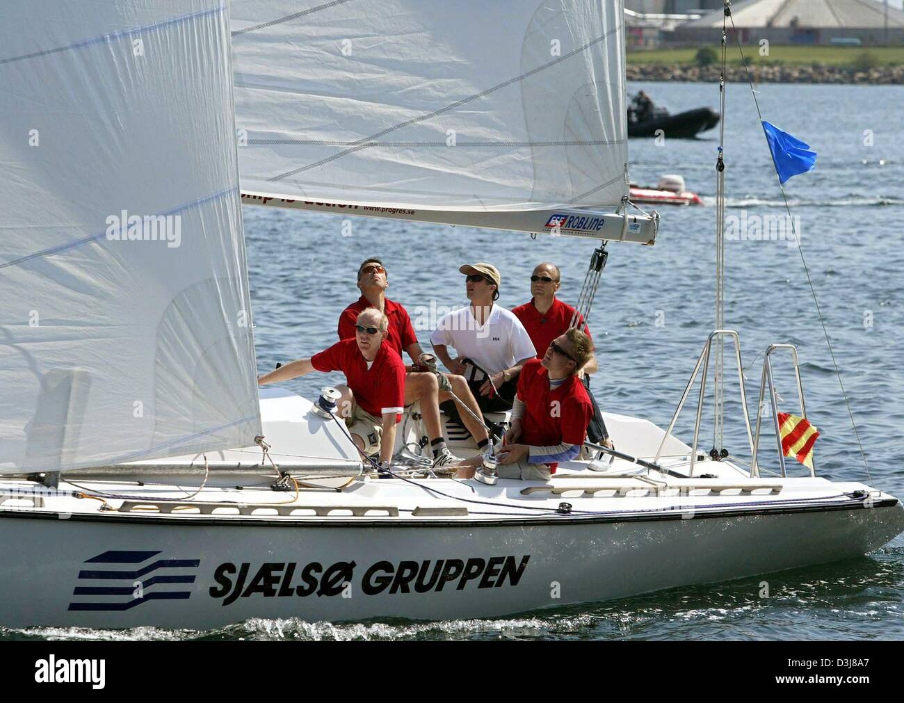 (dpa) - Crown prince Frederik of Denmark (C) sails with his crew during a sailing regatta in the harbour of Copenhagen, Denmark, 9 May 2004. Frederik and Mary Donaldson, his finacee, were competing with each other in a sailing regatta which was eventually won by Mary. Stock Photo