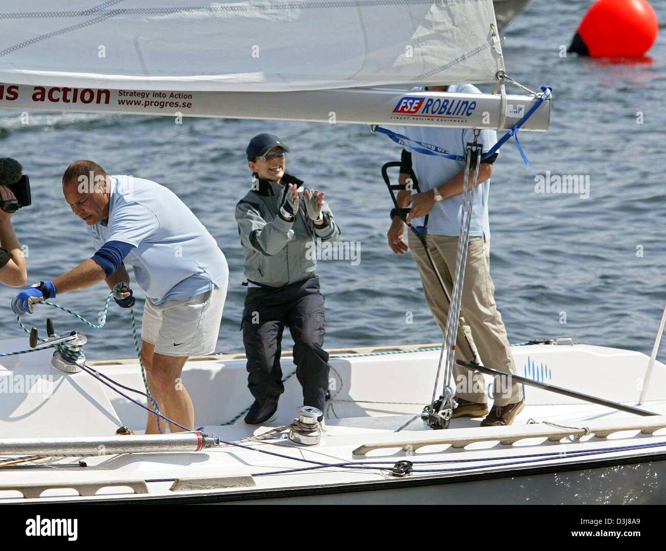 (dpa) - Mary Donaldson (C), fiancee of  Crown prince Frederik of Denmark, smiles and gestures as she sails with her crew during a sailing regatta in the harbour of Copenhagen, Denmark, 9 May 2004. Mary and Frederik were competing with each other in a sailing regatta which was eventually won by Mary. Stock Photo