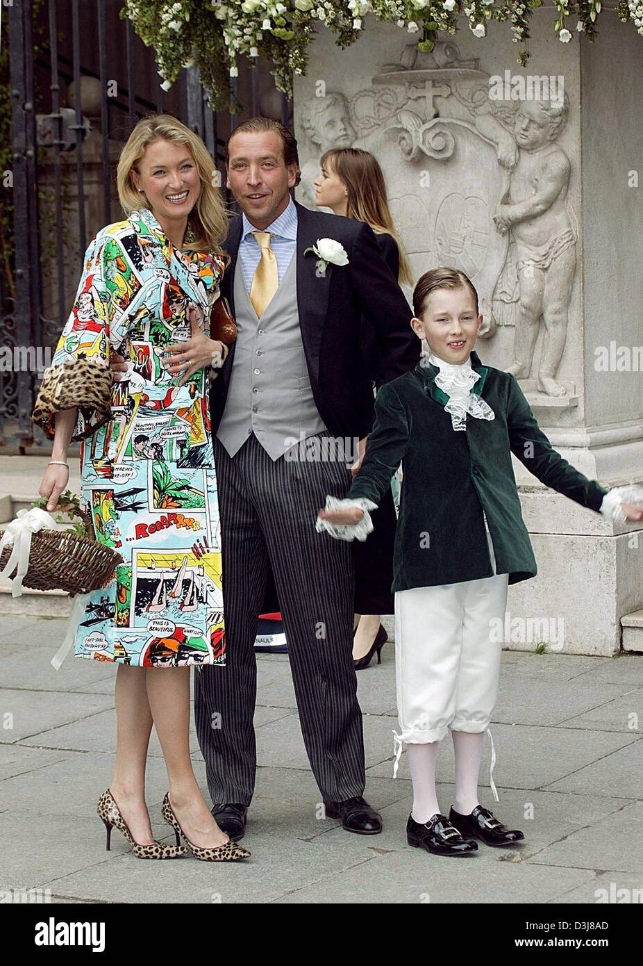 (dpa) - Lilly, princess of Schaumburg-Lippe (L) smiles as she arrives with her son prince Heinrich-Donatus (R) and her second husband and fashion designer Lambros Milona at the wedding of Sven Ley and Zoe Appleyard at the cathedral in Salzburg, Austria, 8 May 2004. Stock Photo