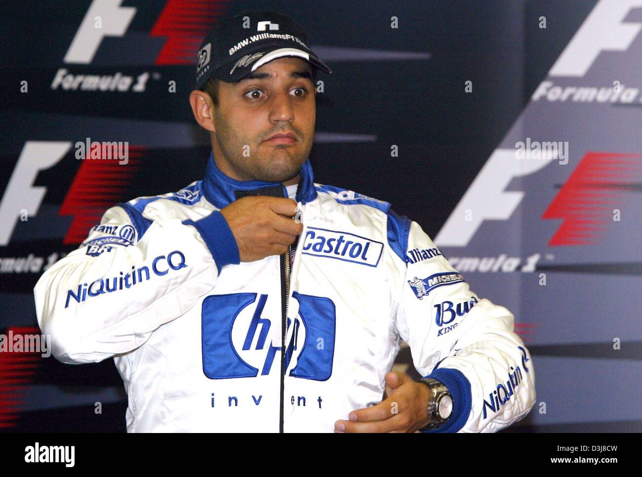 (dpa) - Colombian formula one pilot Juan Pablo Montoya of BMW Williams closes the zipper of his race suit on the Circuit de Catalunya near Barcelona, Spain, 8 May 2004. The Formula 1 Grand Prix of Spain will take place on 9 May 2004. Stock Photo