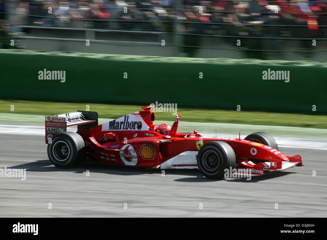 (dpa) - Michael Schumacher (Team Ferrari) raises a fist in triumph after winning the 2004 San Marino Grand Prix in Imola, Italy, 25 April 2004. Stock Photo