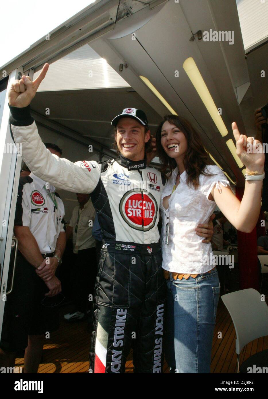 (dpa) - English Formula One pilot Jenson Button (Team BAR-Honda) smiles and celebrates with his girlfriend Louise Griffiths (R) after winning his first ever pole position at the San Marino Grand Prix in Imola, Italy, 24 April 2004. He would finish the race in second place a day later. Stock Photo