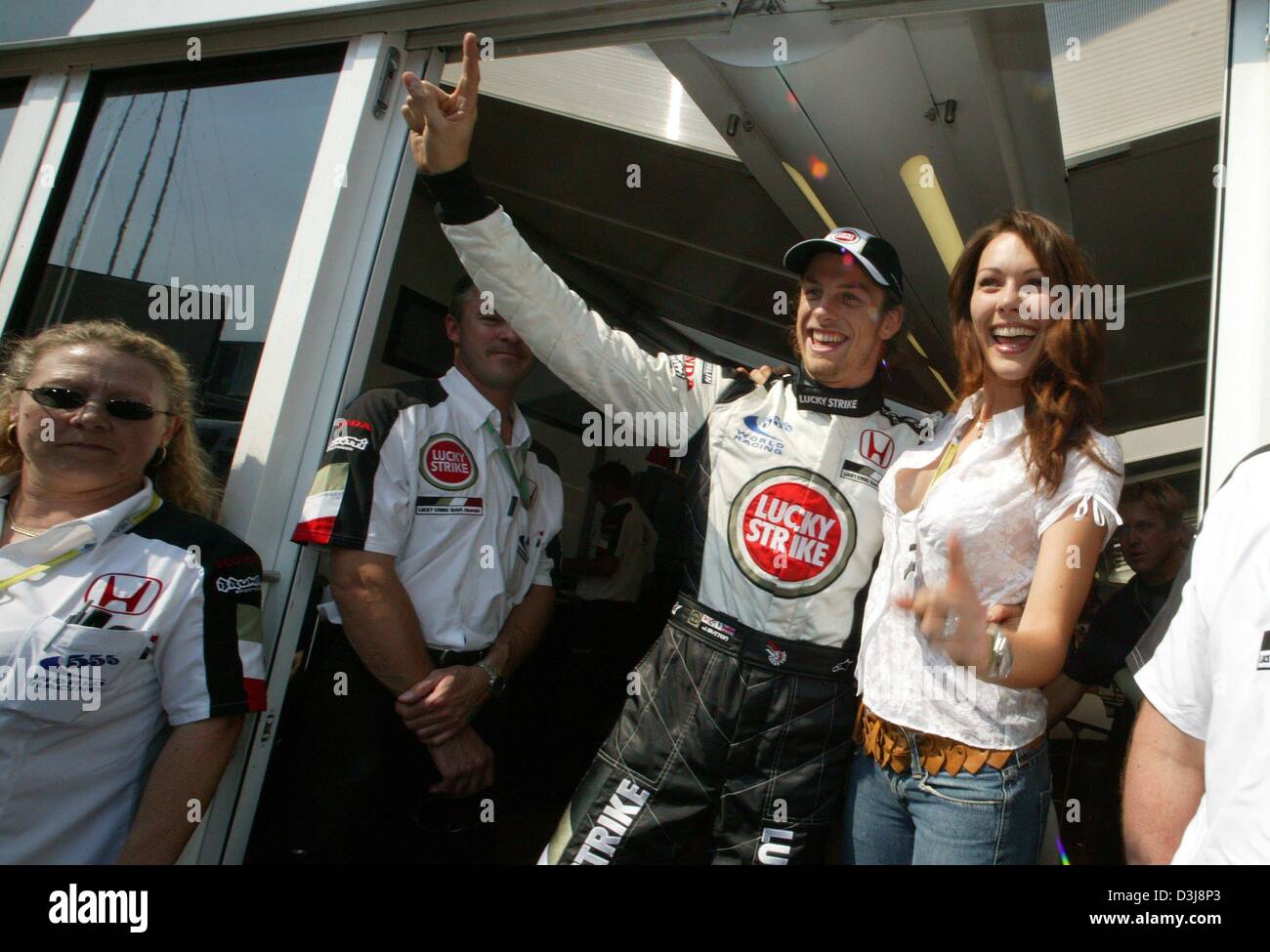 (dpa) - English Formula One pilot Jenson Button (Team BAR-Honda) smiles and celebrates with his girlfriend Louise Griffiths (R) after winning his first ever pole position at the San Marino Grand Prix in Imola, Italy, 24 April 2004. He would finish the race in second place a day later. Stock Photo