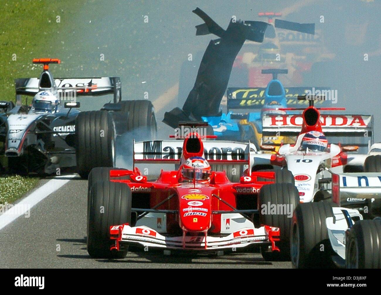 (dpa) - Scottish formula one pilot David Coulthard (L) (McLaren Mercedes) loses his front spoiler after a collision in the first curve and runs off the track during the San Marino grand prix in Imola, Italy, 25 April 2004. Stock Photo