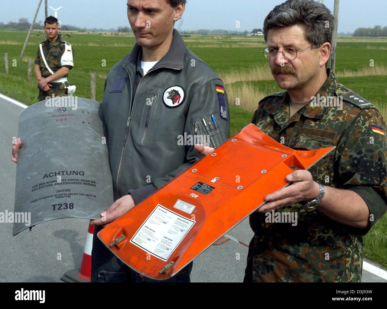 (dpa) - Soldiers of the German 'Bundeswehr' show the recovered flight recorders of two German Tornado fighter jets which collided in mid-air near the town of Garding, northern Germany, on Wednesday, 21 April 2004. Two crew members were killed in the crash but two others were able to parachute to safety, police said. Stock Photo