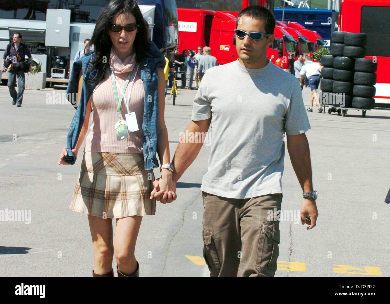 (dpa) - Columbian race car driver Juan Pablo Montoya (Team BMW-Williams) and his wife Connie (L) arrive at the race track 'Enzo e Dino Ferrari' in Imola, Italy, on Thursday 22 April 2004. The first European race of the F1 season will take place in Imola with the San Marino Grand Prix this coming Sunday. Stock Photo