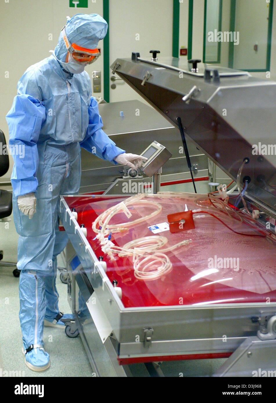 (dpa files) - A laboratory worker stands next to a fermenter in which a vaccine against smallpox is produced, at the vaccine factory Impfstoffwerk Dessau-Tornau near Dessau, eastern Germany, 23 October 2003. The company, which can trace its history back to 1921, currently employs 250 staff and produces various vaccines for human and veterinary medicine. Stock Photo