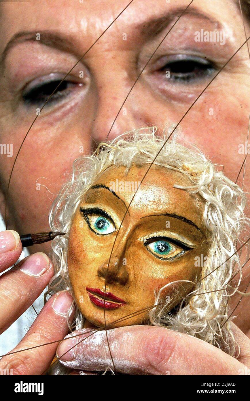 (dpa) - Puppet-maker Doris Schlott decorates the head of a puppet in her workshop in Neu Nantrow, Germany 18 March 2004. Schlott has been working with puppets for the past 30 years crafting at least 50 differen characters of string puppets, hand puppets, sticket puppets and table figures, etc. Stock Photo