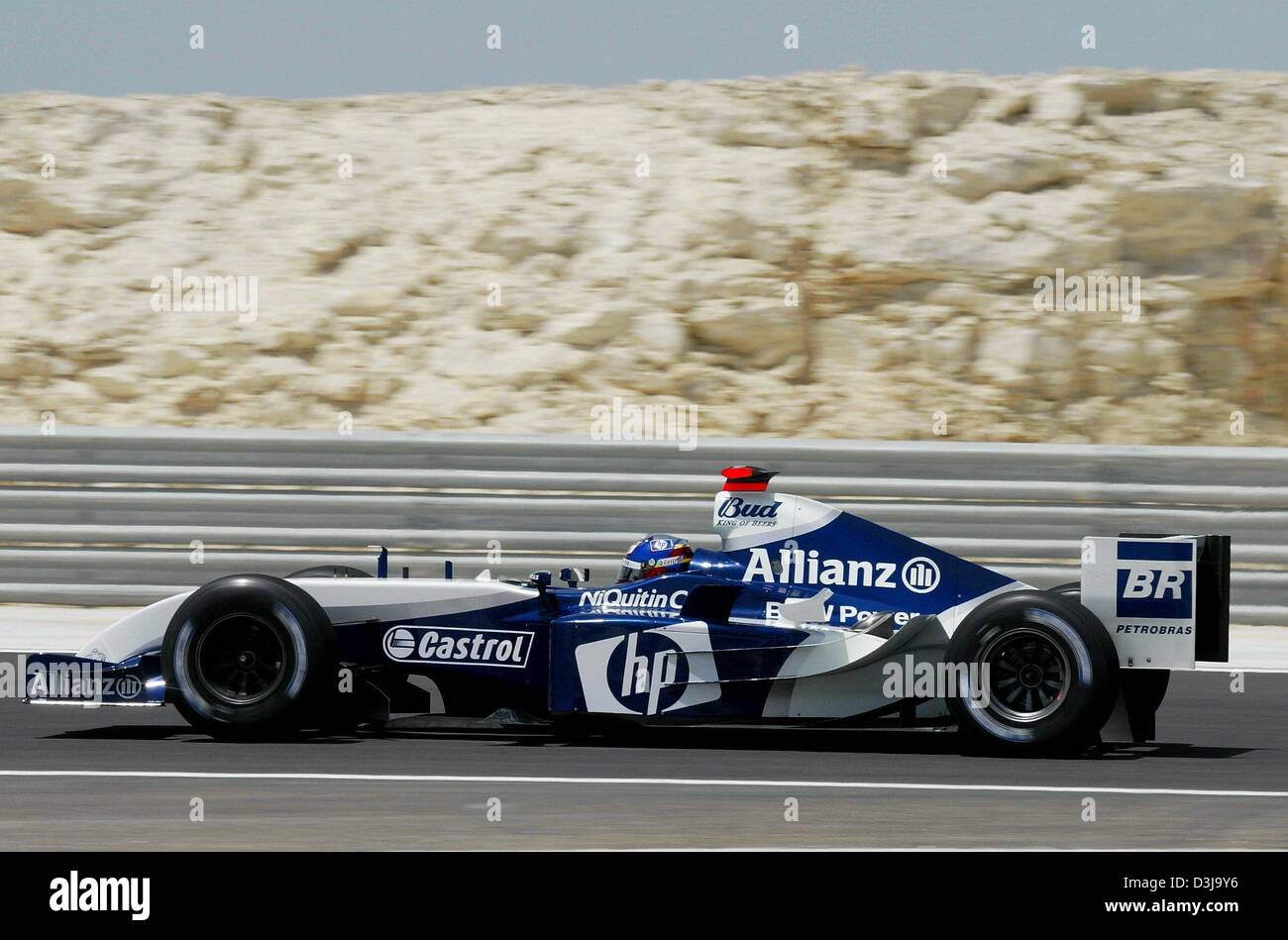 (dpa) - Colombian formula one pilot Juan Pablo Montoya of BMW-Williams steers his bolide along the tarmac of the formula one race course in Manama, Bahrain, on Friday, 2 April 2004. Montoya drove the fourth fastest time in the free practise session in Bahrain. The Formula 1 Grand Prix of Bahrain will take place for the first time this Sunday, 4 April 2004. Stock Photo