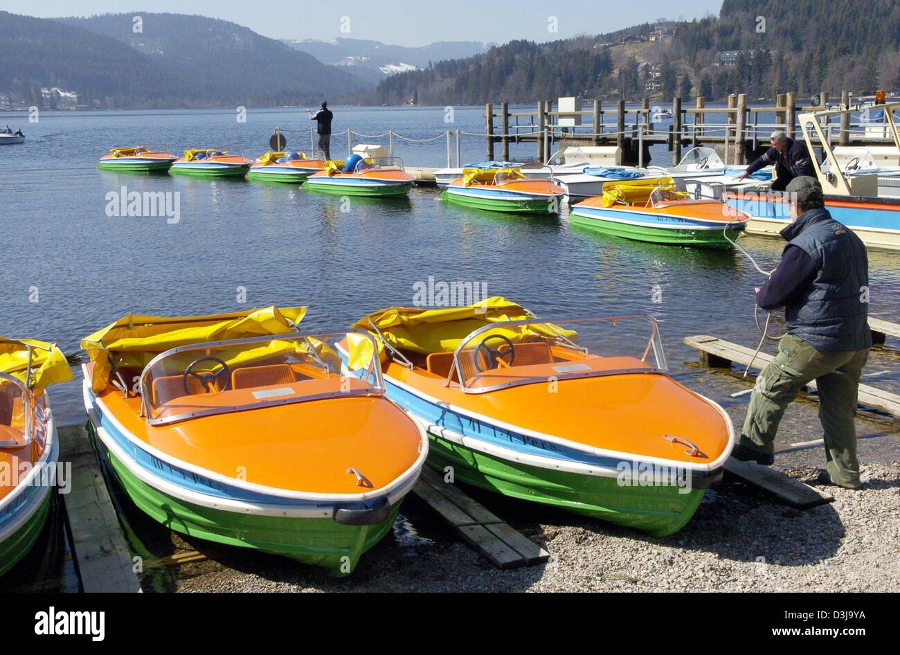 (dpa) - Employees of a boat rental prepare the pedal boats for the summer season on Lake Titi in the Black Forest, in Titisee, Germany, 30 March 2004. With warm temperatures and the Easter holidays approaching, the tourism branch hopes for a good start into the summer season. Stock Photo