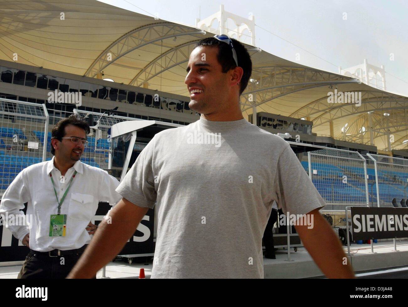 (dpa) The Colombian F1 pilot Juan Pablo Montoya (BMW Williams) walks over  the new Bahrain racetrack on Wednesday, 31 March 2004. On Sunday, 4 April 2004, the Grand Prix of Bahrain will be started. Stock Photo