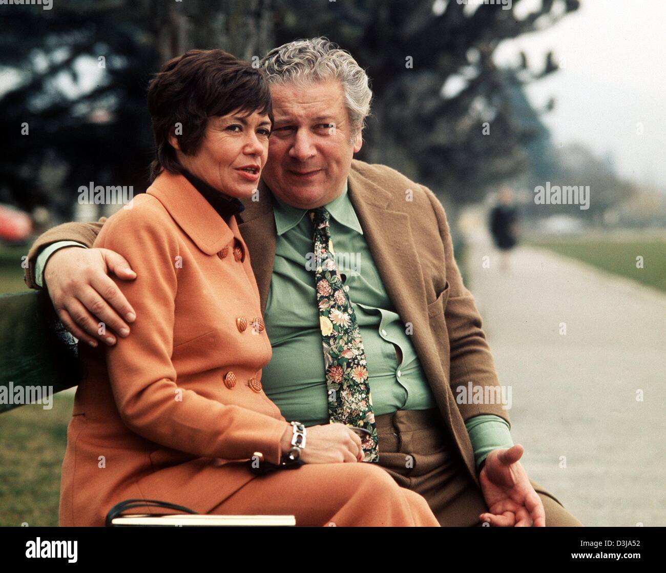 (dpa files) - British actor Peter Ustinov (R) and his third wife Helene sit on a bench at the embankment of Lake Geneva in Bursins, Switzerland, 20 February 1974. Ustinov died at the age of 82 in a hopsital in Geneva on 29 March 2004. He won two Oscars for his parts in 'Spartacus' (1959) and in 'Topkapi' (1964). Ustinov also wrote screenplays, novels and plays and was involved as U Stock Photo