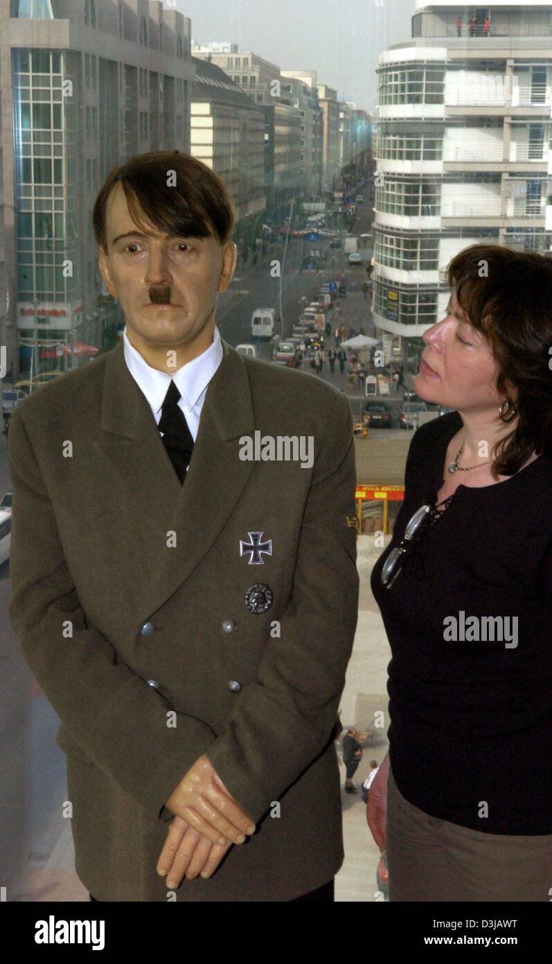 (dpa) A wax figure of Adolf Hitler is observed by a visitor at the wax works in the Friedrichstrasse in Berlin on Thursday, 18 March 2004. Since January 2004 this and 70 other prominent wax figures are on display in the fourth floor of abuidling at the famous 'Checkpoint Charlie'. All the figures originated from a wax figure collection in the Russian St. Petersburg. Stock Photo