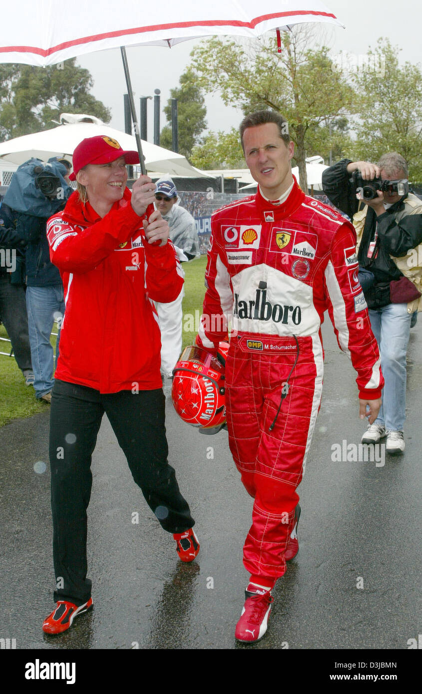dpa) - German Formula One driver Michael Schumacher (R) (Ferrari) and his  spokeswoman Sabine Kehm (L) walk through the paddock with an umbrella at  the formula one racing circuit in Albert Park,