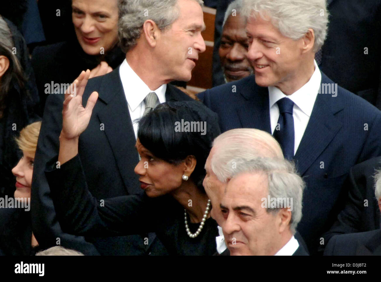 (dpa) - US President George W. Bush and his predecessor Bill Clinton (R) talk with each other, while US Foreign Minister Condoleezza Rice gestures while talking with a colleague, after the funeral service for Pope John Paul II at Saint Peter's Square in the Vatican, Vatican City State, Friday 08 April 2005. The Pope died at the age of 84 last Saturday. Stock Photo