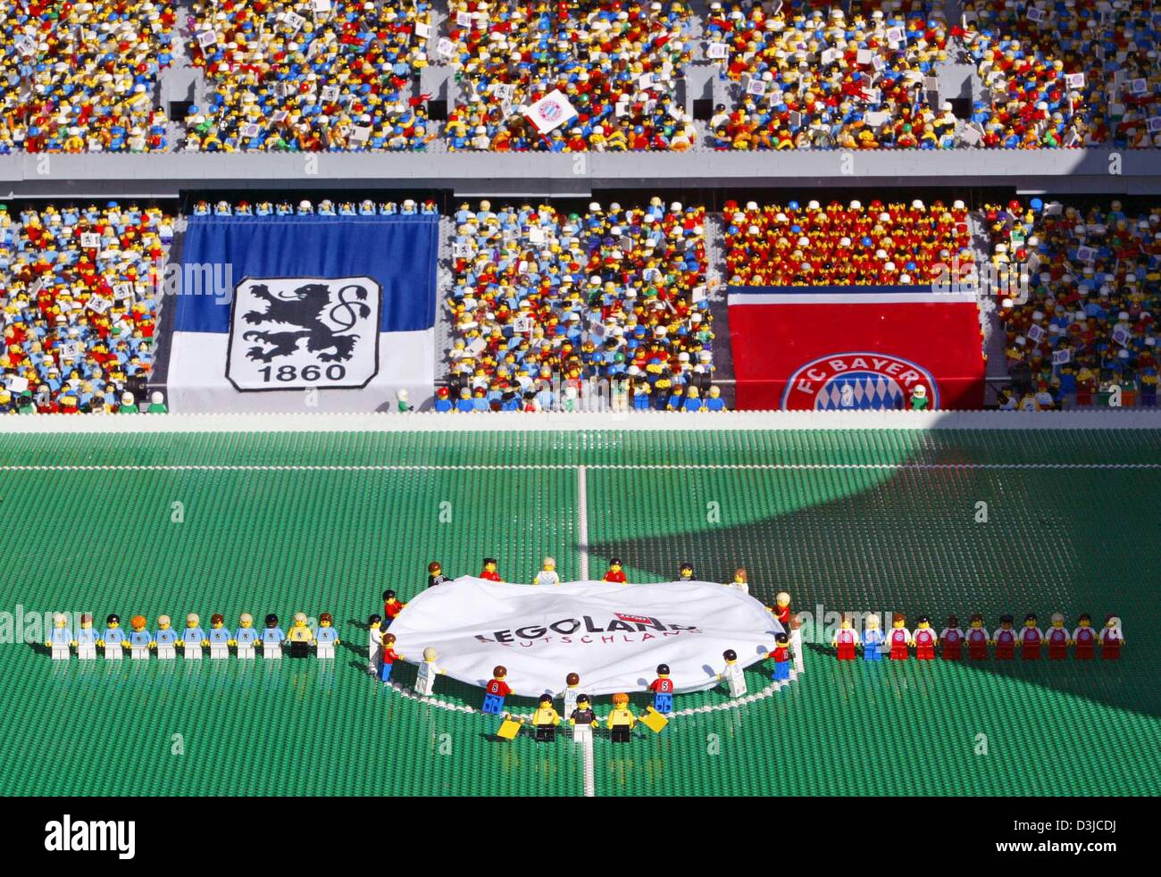 (dpa) - People take a first look at the new design model of Munich's Allianz Arena soccer stadium in Guenzburg, Germany, 12 May 2005. The model is made of one million lego pieces and was introduced to the public 18 days prior to the grand opening of the original stadium in Munich. Stock Photo