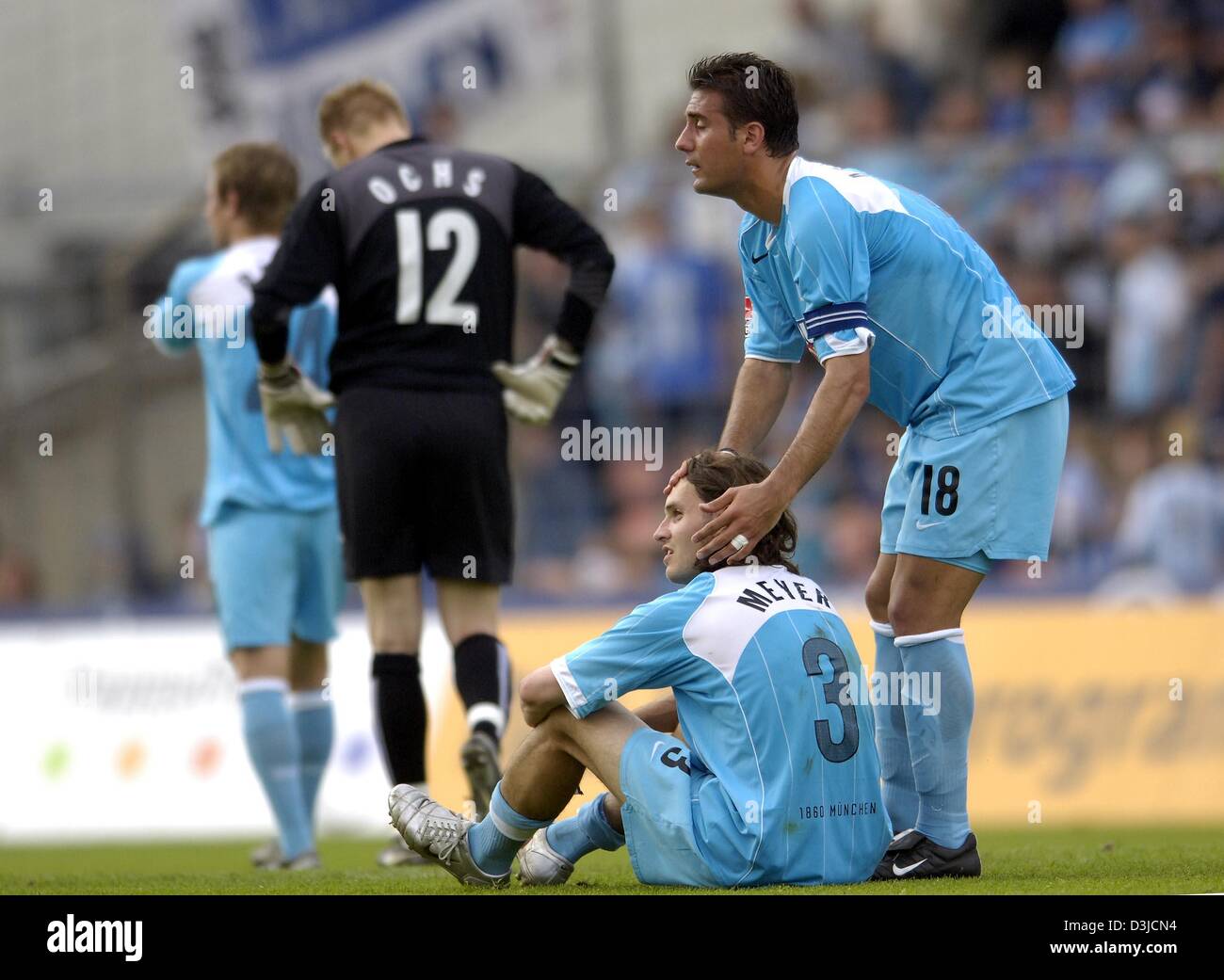 (dpa) - Players Daniel Baier, Timo Ochs, Remo Mayer and Paul Agostino (L-R) of soccer club TSV 1860 Munich look extremely depressed after their 3-4 defeat against LR Ahlen in the Second Bundesliga match at the Gruenwalder stadium in Munich, Germany, 22 May 2005. Munich failed to qualify for Germany's top soccer division. Stock Photo