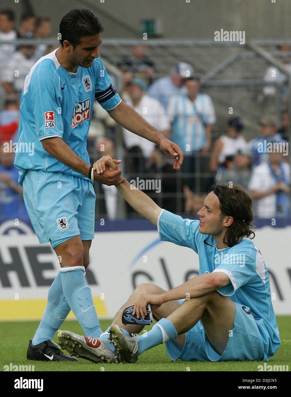 (dpa) - Players Remo Mayer and Paul Agostino (R-L) of soccer club TSV 1860 Munich look extremely depressed after their 3-4 defeat against LR Ahlen in the Second Bundesliga match at the Gruenwalder stadium in Munich, Germany, 22 May 2005. Munich failed to qualify for Germany's top soccer division. Stock Photo