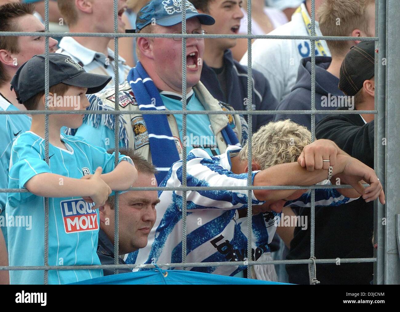 (dpa) - Fans of soccer club TSV 1860 Munich look extremely depressed after their team's 3-4 defeat against LR Ahlen in the Second Bundesliga match at the Gruenwalder stadium in Munich, Germany, 22 May 2005. Munich failed to qualify for Germany's top soccer division. Stock Photo