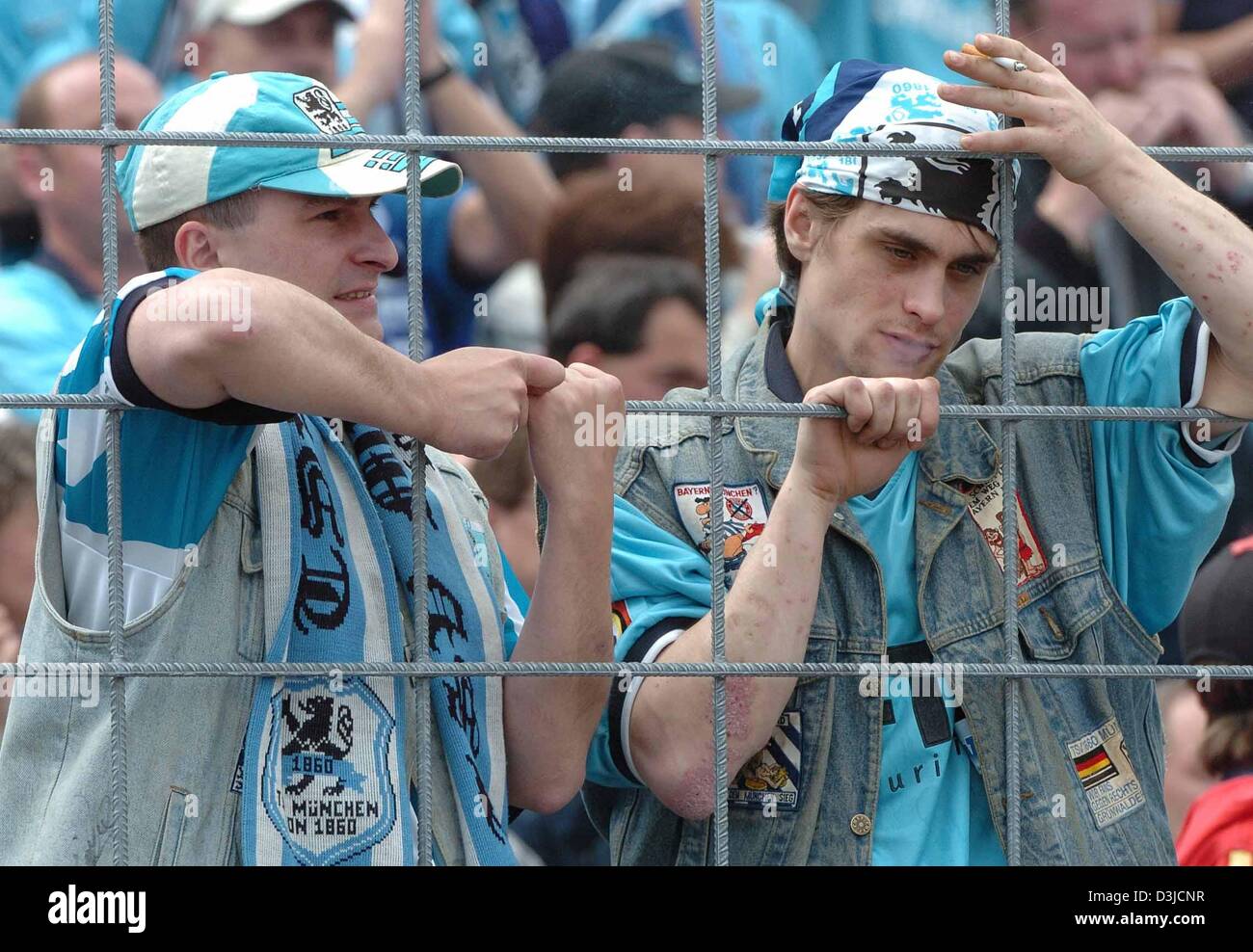(dpa) - Fans of soccer club TSV 1860 Munich look extremely depressed after their team's 3-4 defeat against LR Ahlen in the Second Bundesliga match at the Gruenwalder stadium in Munich, Germany, 22 May 2005. Munich failed to qualify for Germany's top soccer division. Stock Photo