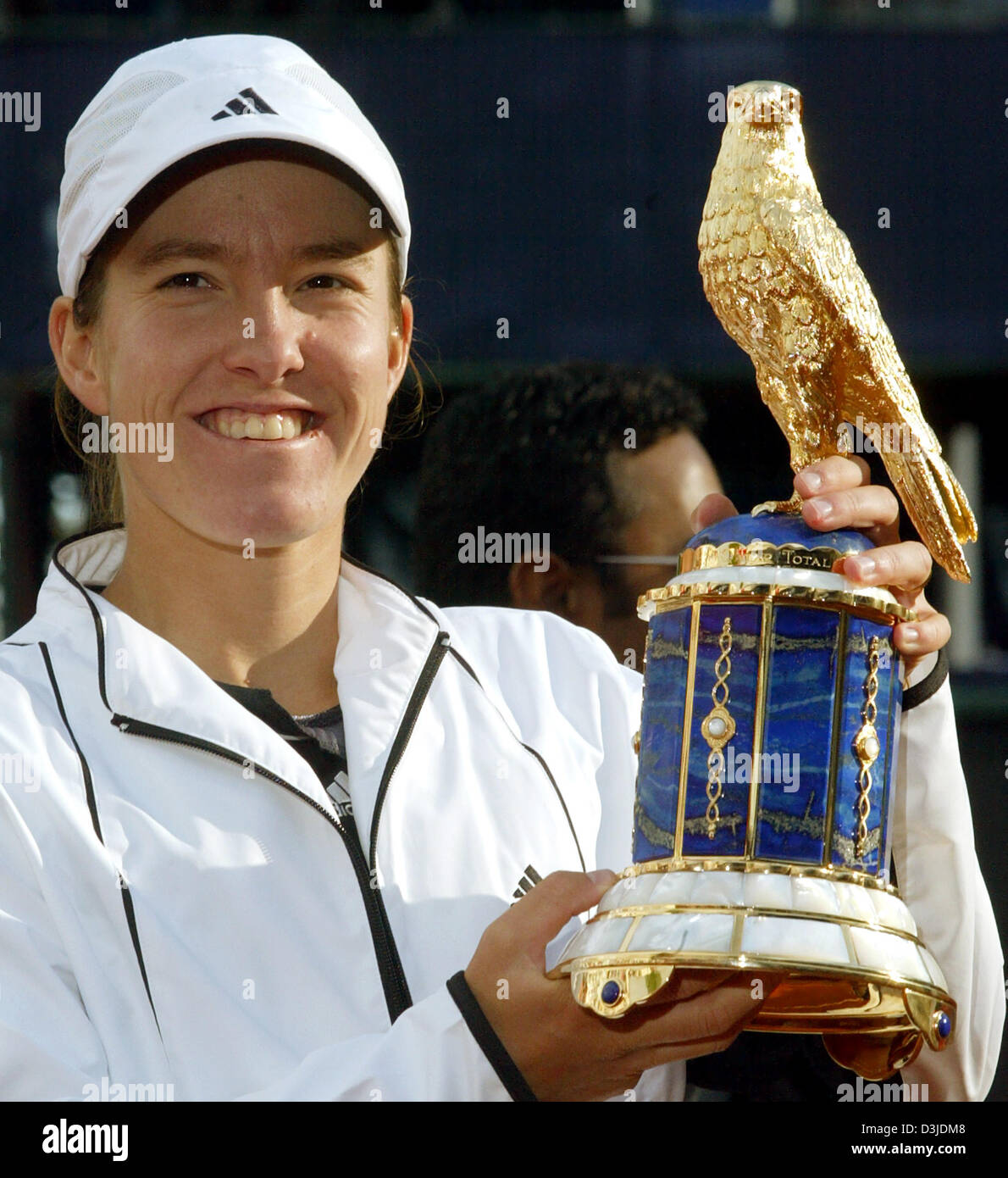 (dpa) Belgian tennis pro Justine Henin-Hardenne smiles while holding the winner trophy after the Qatar Total German Open tennis tournament in Berlin, Germany, 8 May 2005. Henin-Hardenne won the final against Russian Nadja Petrova 6-3, 4-6 and 6-3. Stock Photo