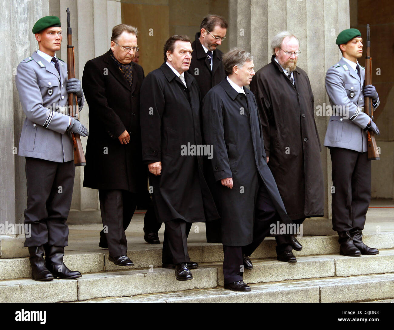 (dpa) - Framed by two guards Federal Constitutional Court President Hans-Juergen Papier, Chancellor Gerhard Schroeder, Federal Council President Matthias Platzeck, Federal President Horst Koehler and Federal Diet President Wolfgang Thierse  (from L to R) leave the Neue Wache in Berlin, Germany, 8 May 2005. The leadership of Germany commemorated the victims of the second World War.  Stock Photo