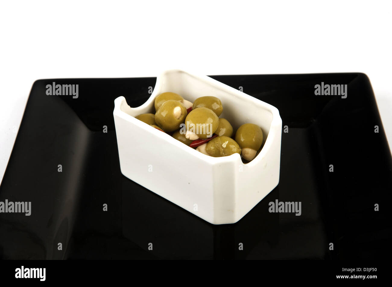 Tesco finest Olives shot in studio displayed against a white background. Stock Photo