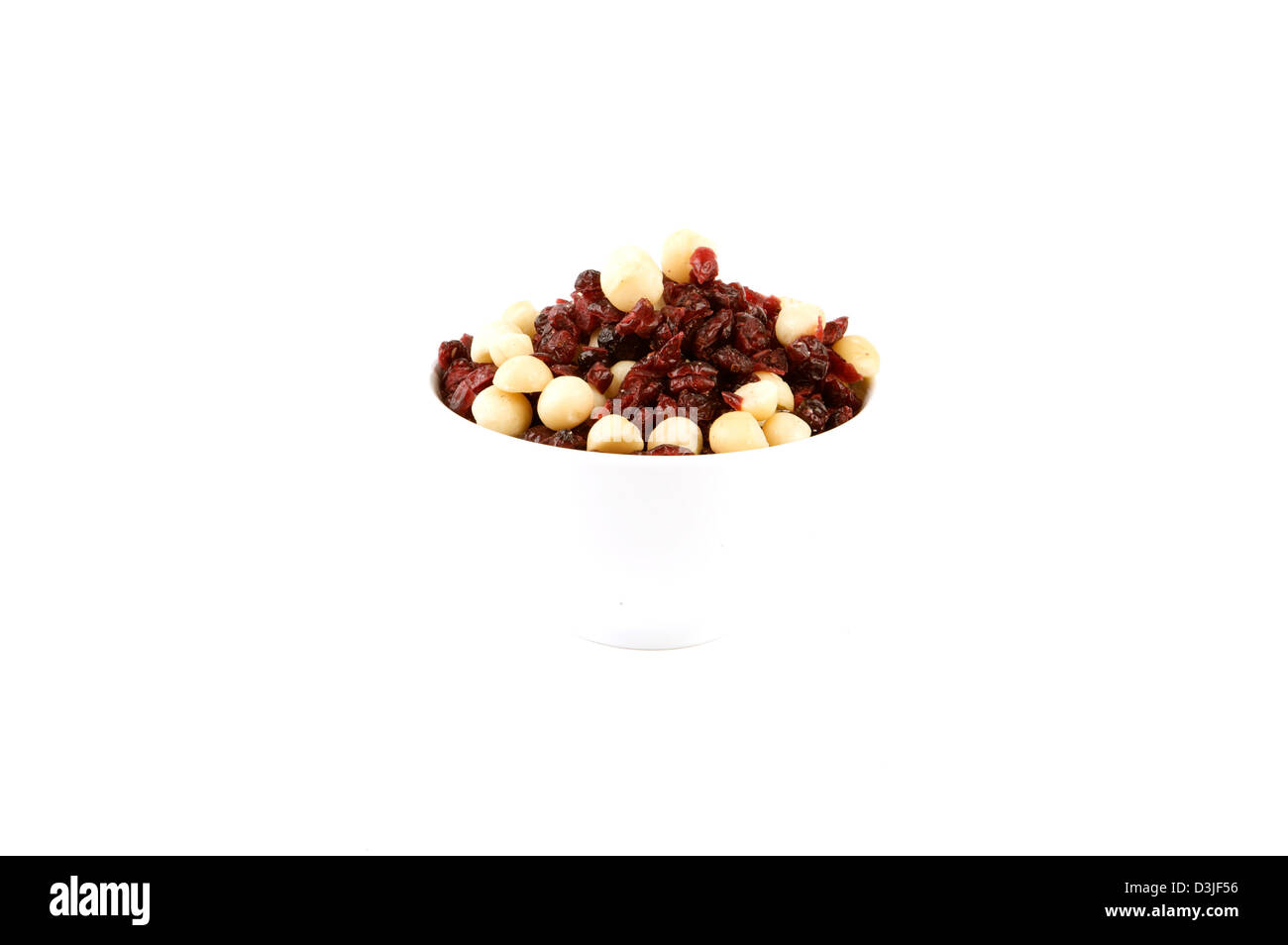 A bowl of mixed nuts shot on a white high key background Stock Photo