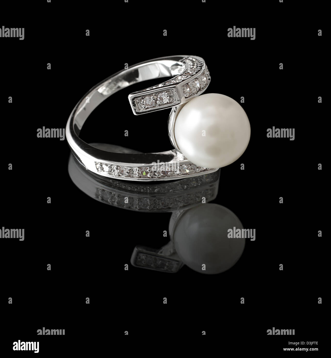 Ring with pearl and diamonds on black background Stock Photo